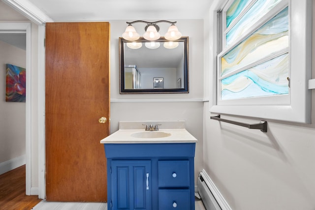 97 Forest Ave, Orono, ME 04473 - bathroom with vanity, baseboard heating, and wood finished floors