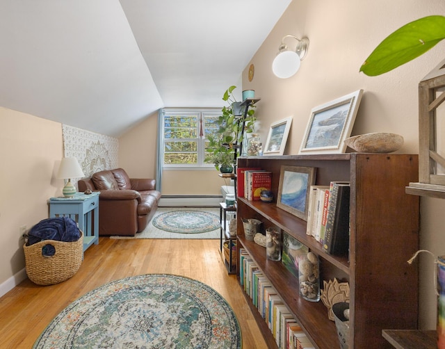 97 Forest Ave, Orono, ME 04473 - living area with a baseboard heating unit, wood finished floors, and lofted ceiling
