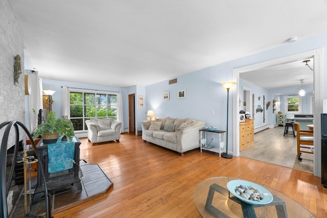 97 Forest Ave, Orono, ME 04473 - living room featuring light wood-type flooring and a baseboard radiator