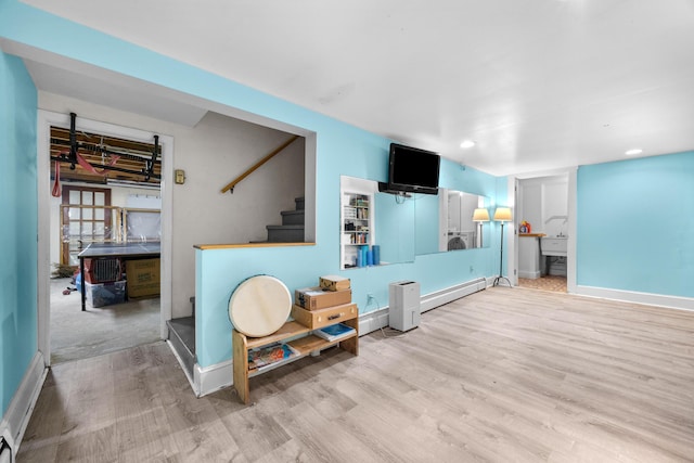 97 Forest Ave, Orono, ME 04473 - living room with wood finished floors, stairs, recessed lighting, and baseboard heating