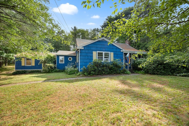97 Forest Ave, Orono, ME 04473 - bungalow-style home with a front yard and a chimney