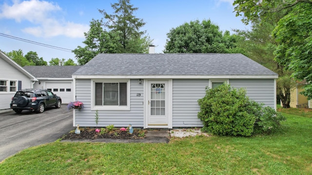 119 Falvey St, Bangor, ME 04401 - view of front of property with a garage, asphalt driveway, roof with shingles, a front lawn, and a chimney