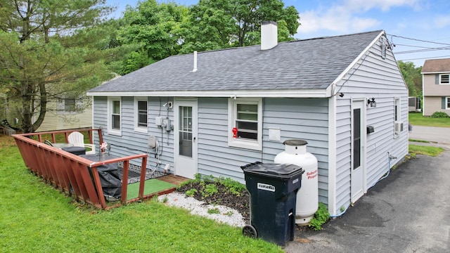 119 Falvey St, Bangor, ME 04401 - rear view of house featuring a shingled roof, a chimney, and a yard