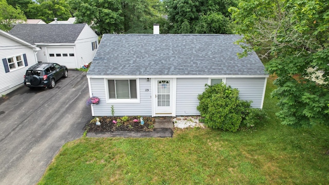 119 Falvey St, Bangor, ME 04401 - view of front facade with roof with shingles, driveway, a front lawn, and an attached garage