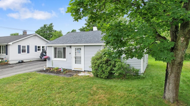 119 Falvey St, Bangor, ME 04401 - view of front of house featuring roof with shingles and a front lawn