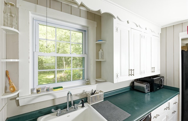 302 Townsend Ave, Boothbay Harbor, ME 04538 - kitchen featuring ornamental molding, freestanding refrigerator, dark countertops, open shelves, and white cabinetry