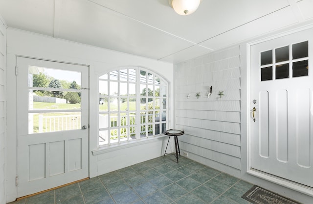 302 Townsend Ave, Boothbay Harbor, ME 04538 - doorway to outside with healthy amount of natural light and dark tile patterned floors