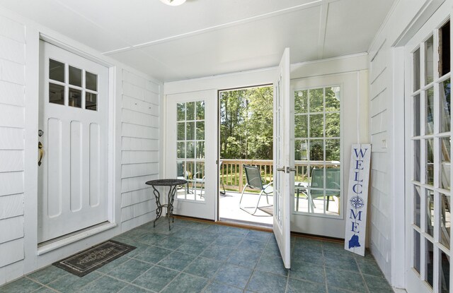 302 Townsend Ave, Boothbay Harbor, ME 04538 - doorway featuring dark tile patterned flooring, healthy amount of natural light, and ornamental molding