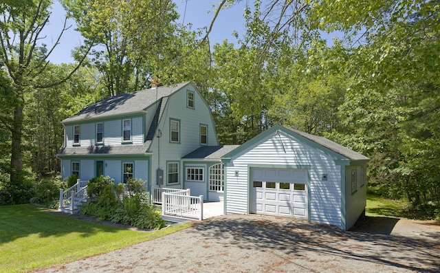302 Townsend Ave, Boothbay Harbor, ME 04538 - colonial inspired home with a garage, driveway, a front lawn, a shingled roof, and view of wooded area