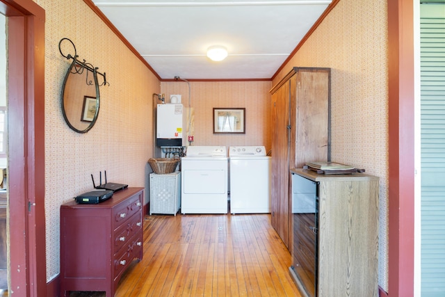 426 Meadow Rd, Topsham, ME 04086 - laundry area with wallpapered walls, washer and dryer, crown molding, light wood-type flooring, and water heater