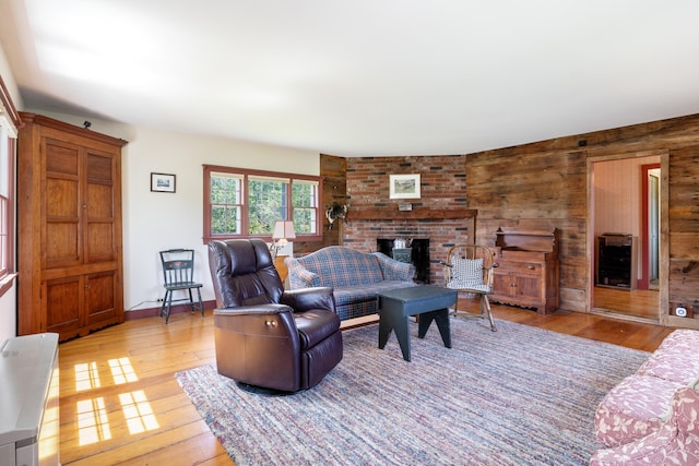 426 Meadow Rd, Topsham, ME 04086 - living room with a fireplace, light wood-type flooring, and wood walls
