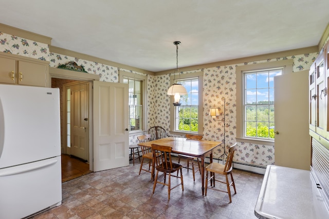 426 Meadow Rd, Topsham, ME 04086 - dining area featuring wallpapered walls, baseboard heating, stone finish flooring, and a baseboard heating unit