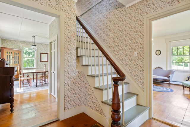 426 Meadow Rd, Topsham, ME 04086 - stairs with wallpapered walls, wood finished floors, and crown molding