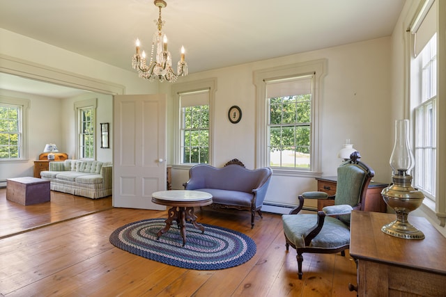 426 Meadow Rd, Topsham, ME 04086 - living room featuring a chandelier, wood-type flooring, and baseboard heating