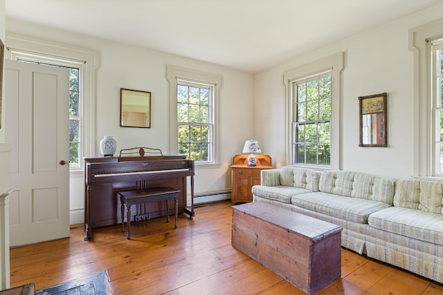 426 Meadow Rd, Topsham, ME 04086 - living room with plenty of natural light, light wood finished floors, and a baseboard heating unit