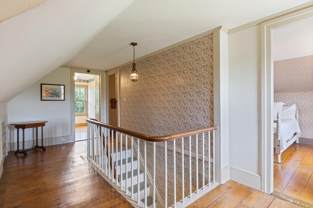 426 Meadow Rd, Topsham, ME 04086 - hall with wallpapered walls, wood-type flooring, vaulted ceiling, and an upstairs landing