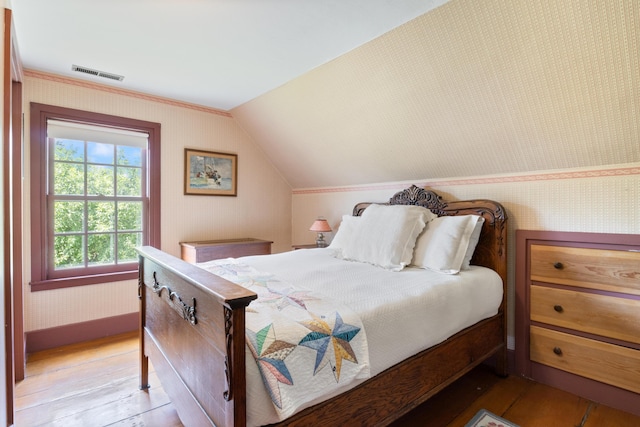 426 Meadow Rd, Topsham, ME 04086 - bedroom with wallpapered walls, lofted ceiling, and light wood finished floors