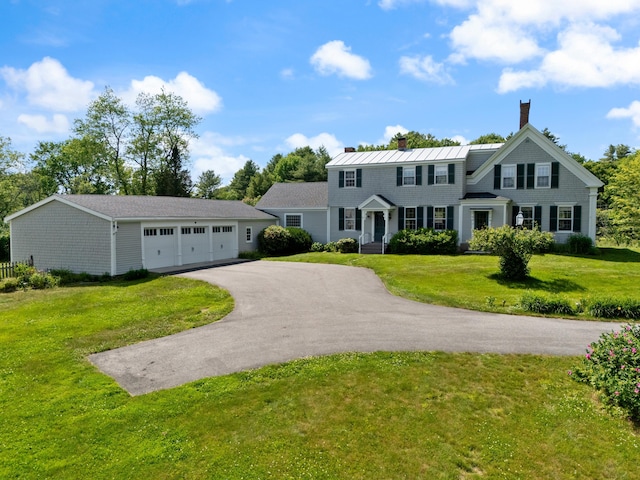 426 Meadow Rd, Topsham, ME 04086 - view of front of property featuring asphalt driveway, a chimney, a front yard, and a garage