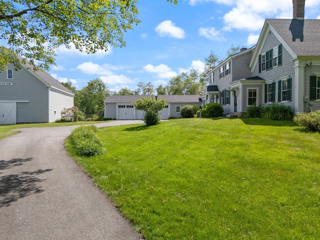 426 Meadow Rd, Topsham, ME 04086 - view of green lawn with driveway, a garage, and a residential view
