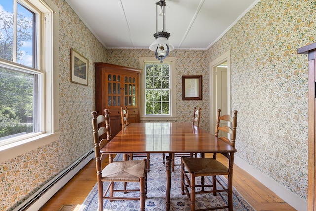 426 Meadow Rd, Topsham, ME 04086 - dining space featuring ornamental molding, light wood-style flooring, a baseboard radiator, and wallpapered walls