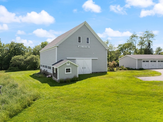 426 Meadow Rd, Topsham, ME 04086 - view of home's exterior featuring an outbuilding, a lawn, and a barn