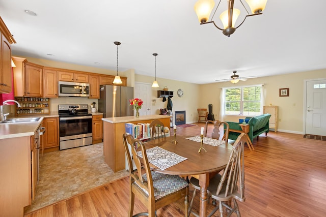 31 Silas Warren Dr, Hermon, ME 04401 - dining area featuring light wood-style floors, ceiling fan, and a chandelier