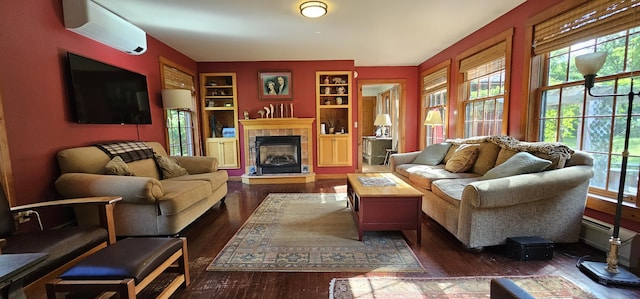 987 Clinton Ave, Winslow, ME 04901 - living room featuring a wall mounted AC, plenty of natural light, dark wood-style floors, and built in shelves
