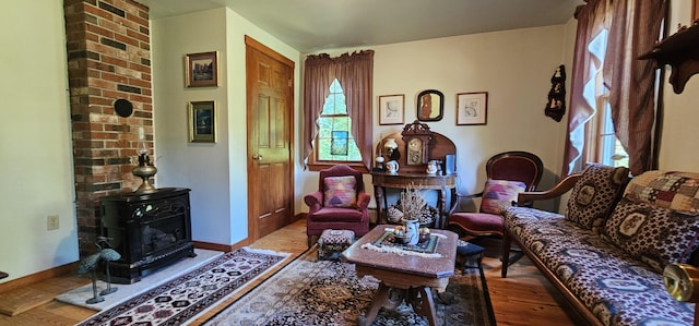 987 Clinton Ave, Winslow, ME 04901 - living area featuring a wood stove and wood finished floors