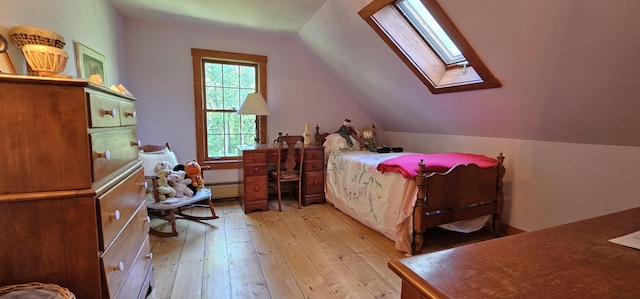 987 Clinton Ave, Winslow, ME 04901 - bedroom with a skylight, light wood-type flooring, lofted ceiling, and a baseboard heating unit