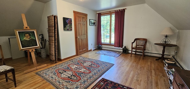 987 Clinton Ave, Winslow, ME 04901 - entryway featuring wood finished floors, vaulted ceiling, and a baseboard radiator