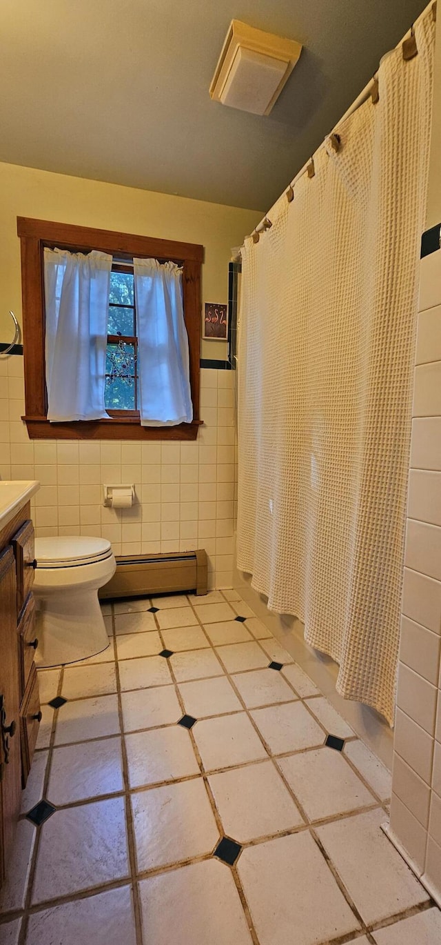 987 Clinton Ave, Winslow, ME 04901 - full bath with baseboard heating, tile walls, vanity, a shower with shower curtain, and tile patterned flooring
