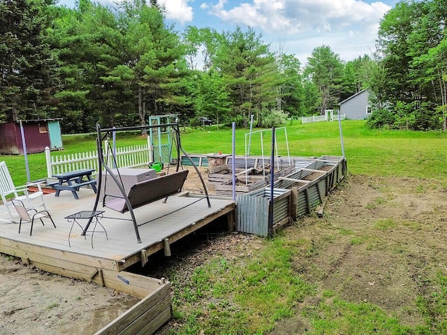 71 Morgan Rd, Burnham, ME 04922 - wooden deck featuring a lawn, a garden, and a shed