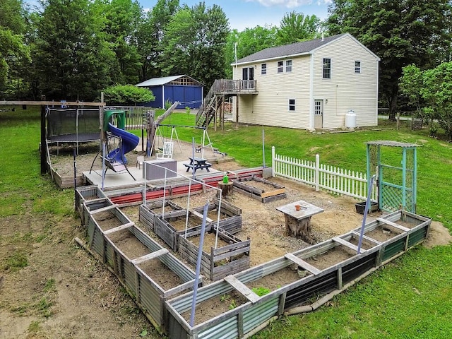 71 Morgan Rd, Burnham, ME 04922 - view of yard with a garden, stairs, a deck, a trampoline, and view of scattered trees