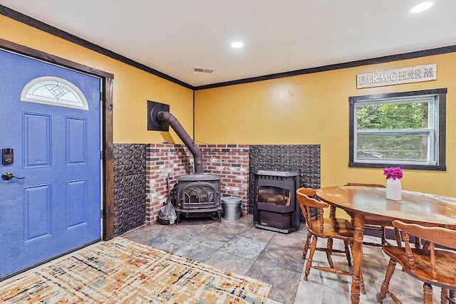 71 Morgan Rd, Burnham, ME 04922 - foyer entrance featuring a wood stove, crown molding, and recessed lighting
