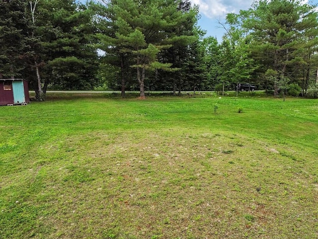 71 Morgan Rd, Burnham, ME 04922 - view of grassy yard featuring a storage shed