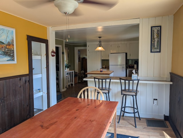 419 Common Rd, Union, ME 04862 - dining space with ceiling fan, light wood-style floors, and wainscoting