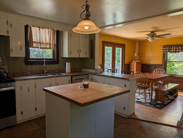419 Common Rd, Union, ME 04862 - kitchen with wood counters, appliances with stainless steel finishes, healthy amount of natural light, a peninsula, and a wainscoted wall
