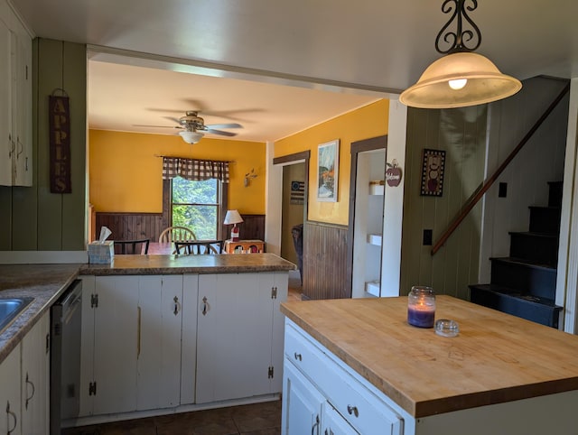 419 Common Rd, Union, ME 04862 - kitchen with butcher block counters, dishwasher, a ceiling fan, wainscoting, and a peninsula