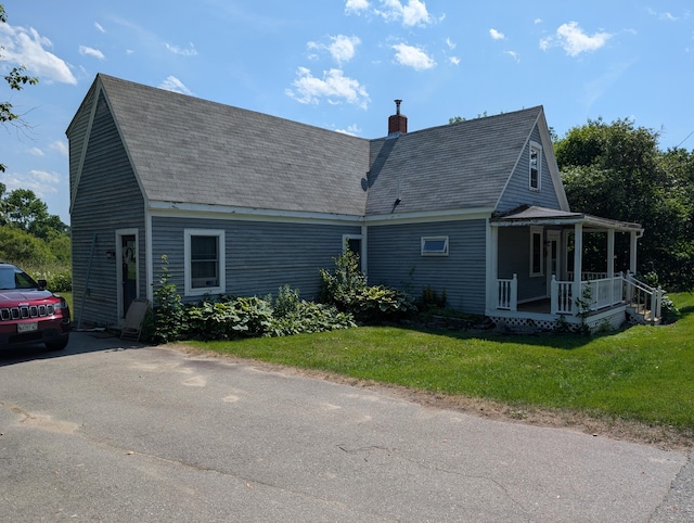 419 Common Rd, Union, ME 04862 - view of side of home with a porch, a chimney, a lawn, and roof with shingles