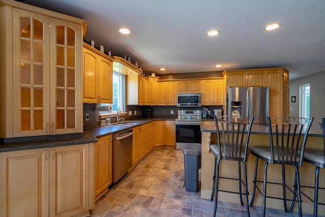 78 Lakeview Rd, Glenburn, ME 04401 - kitchen featuring stainless steel appliances, a breakfast bar, recessed lighting, glass insert cabinets, and a center island