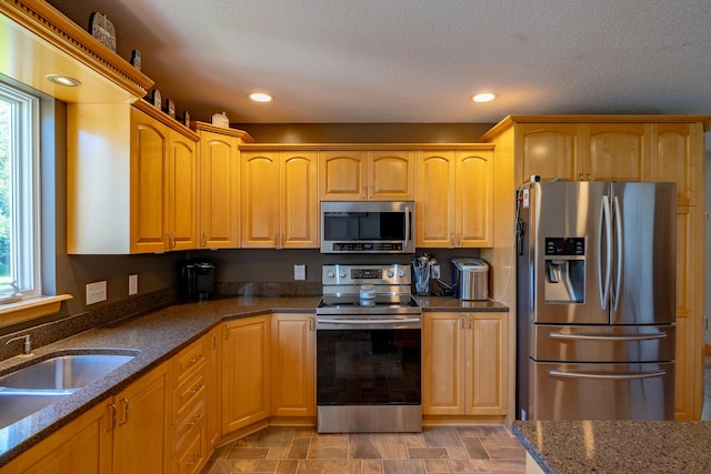 78 Lakeview Rd, Glenburn, ME 04401 - kitchen featuring stainless steel appliances, healthy amount of natural light, dark stone countertops, recessed lighting, and a textured ceiling