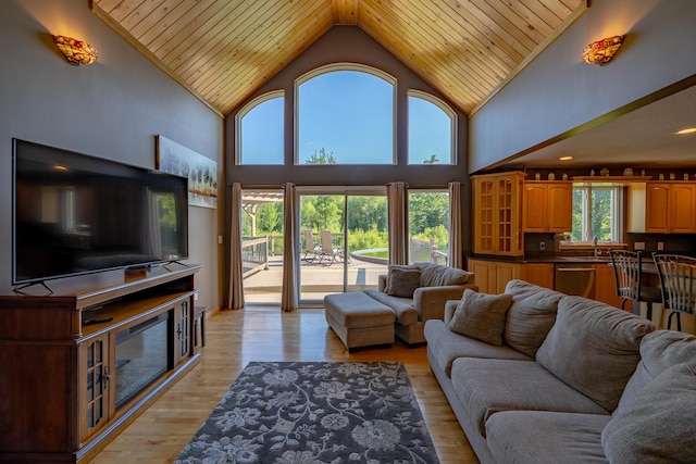 78 Lakeview Rd, Glenburn, ME 04401 - living area with high vaulted ceiling, wooden ceiling, and light wood-style floors