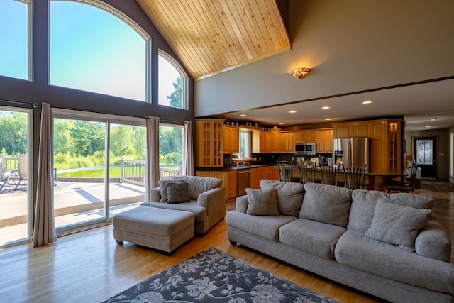 78 Lakeview Rd, Glenburn, ME 04401 - living room with healthy amount of natural light, high vaulted ceiling, recessed lighting, and light wood finished floors