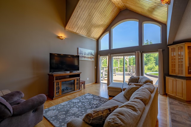 78 Lakeview Rd, Glenburn, ME 04401 - living room featuring plenty of natural light, high vaulted ceiling, wooden ceiling, and a glass covered fireplace