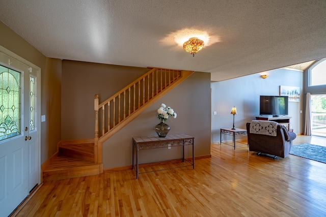 78 Lakeview Rd, Glenburn, ME 04401 - entrance foyer with stairs, wood finished floors, and a textured ceiling