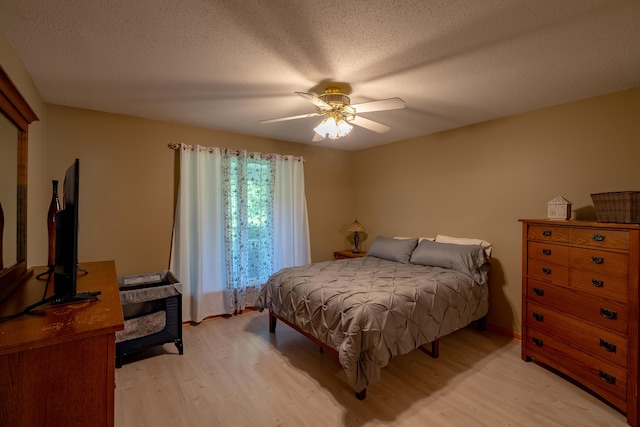 78 Lakeview Rd, Glenburn, ME 04401 - bedroom with light wood-style floors, a ceiling fan, and a textured ceiling
