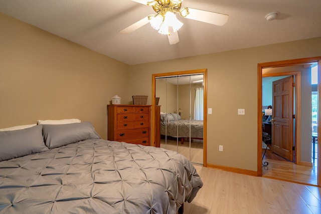 78 Lakeview Rd, Glenburn, ME 04401 - bedroom with light wood-type flooring, a closet, vaulted ceiling, and a ceiling fan