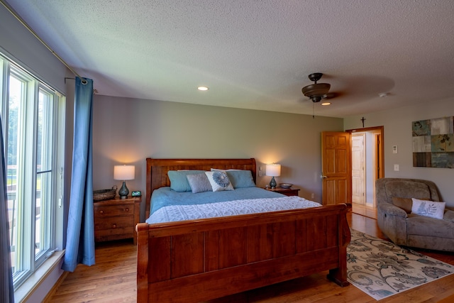 78 Lakeview Rd, Glenburn, ME 04401 - bedroom with multiple windows, a textured ceiling, light wood finished floors, recessed lighting, and ceiling fan