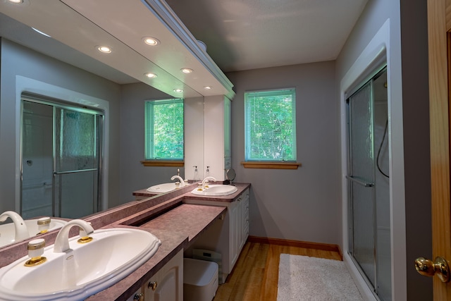 78 Lakeview Rd, Glenburn, ME 04401 - full bathroom with wood finished floors, double vanity, a shower stall, and recessed lighting