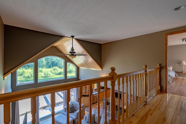 78 Lakeview Rd, Glenburn, ME 04401 - hallway featuring a textured ceiling, wood-type flooring, and an upstairs landing